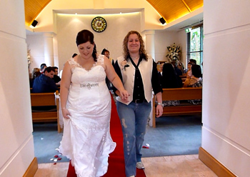 Donna & Bridget walk down the aisle ot the chapel together in the at the Crowne Plaza Surfer's Paradise on the Central Gold Coast.